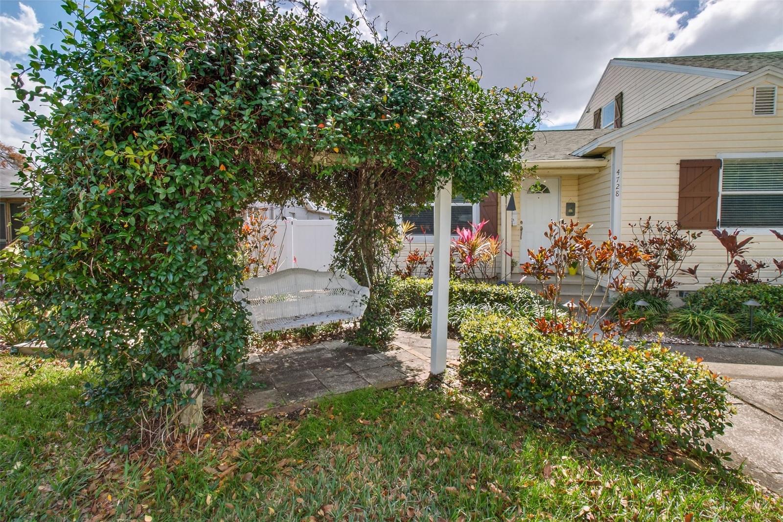 Front of home with Swing and arbor