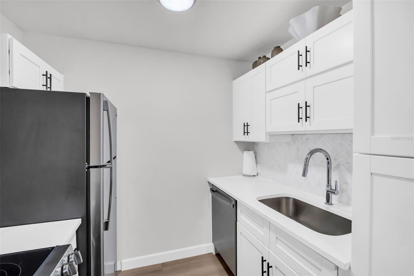 Sleek stainless steel appliances perfectly complement the custom cabinetry and polished fixtures in this gourmet-inspired kitchen.
