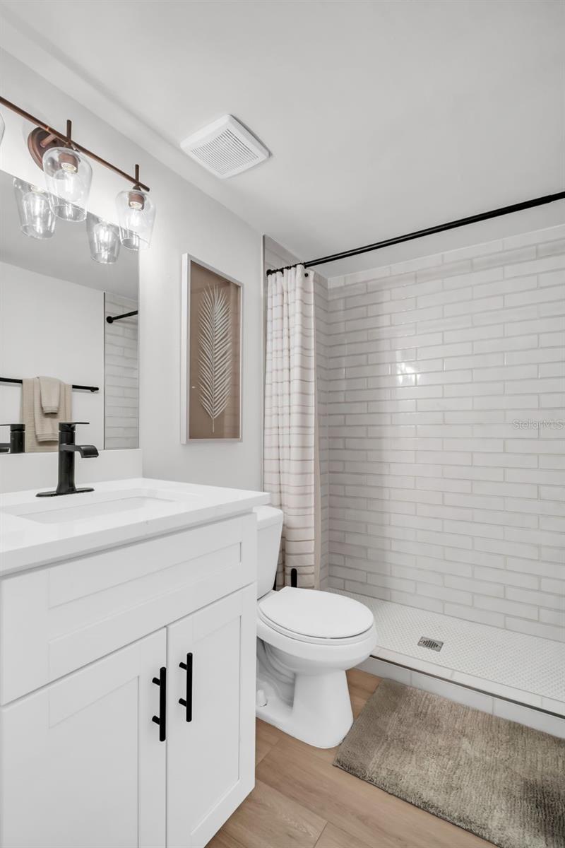 Step into this beautifully designed walk-in shower and enjoy the sleek custom cabinetry.