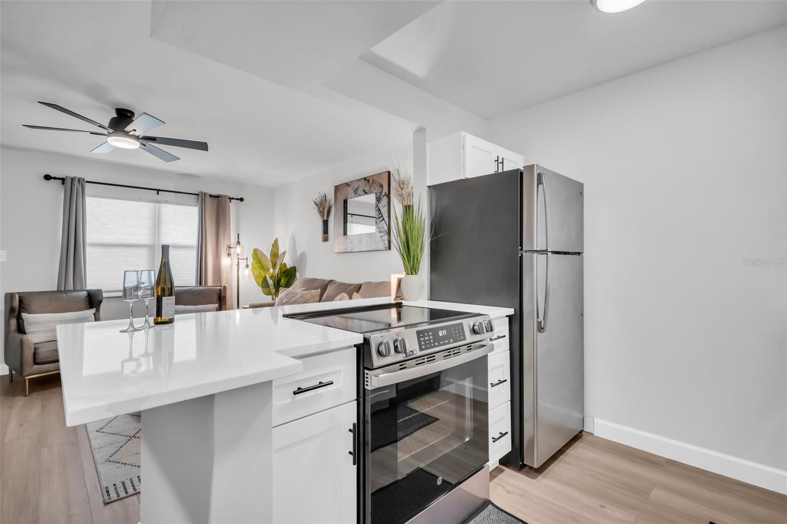 Chef-inspired kitchen featuring professional-grade stainless steel appliances, sleek quartz countertops, and a stunning range that serves as the heart of the home.