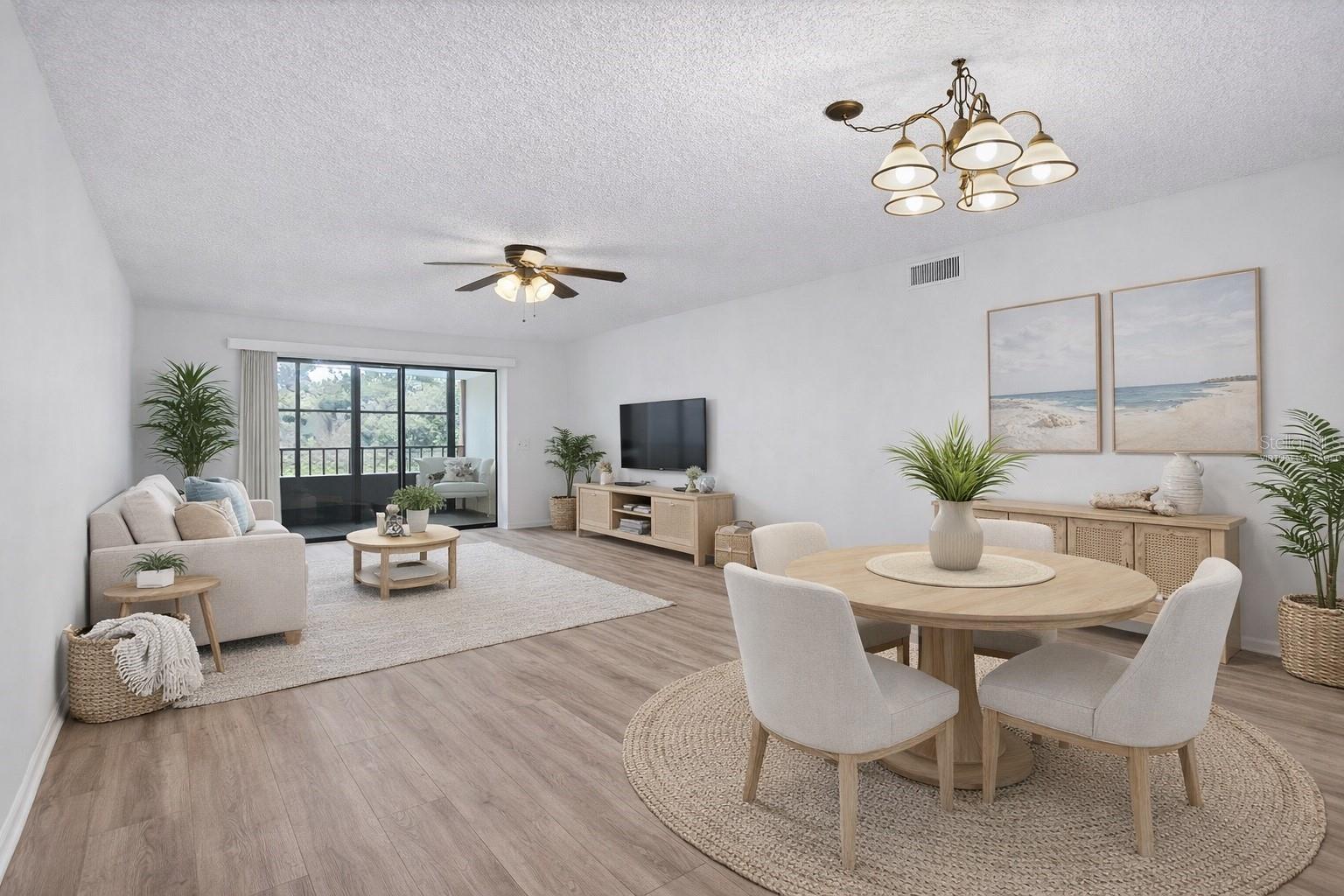 Virtually Staged. Large open living room/dining room area with views of the pond off the balcony!