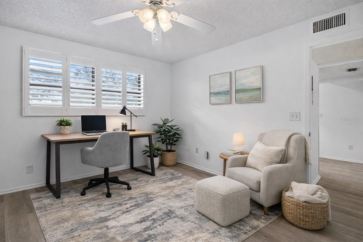 Virtually Staged. 2nd bedroom with a walk in closet and a beautiful Murphy bed with a queen sized mattress and bult in shelves on both sides.