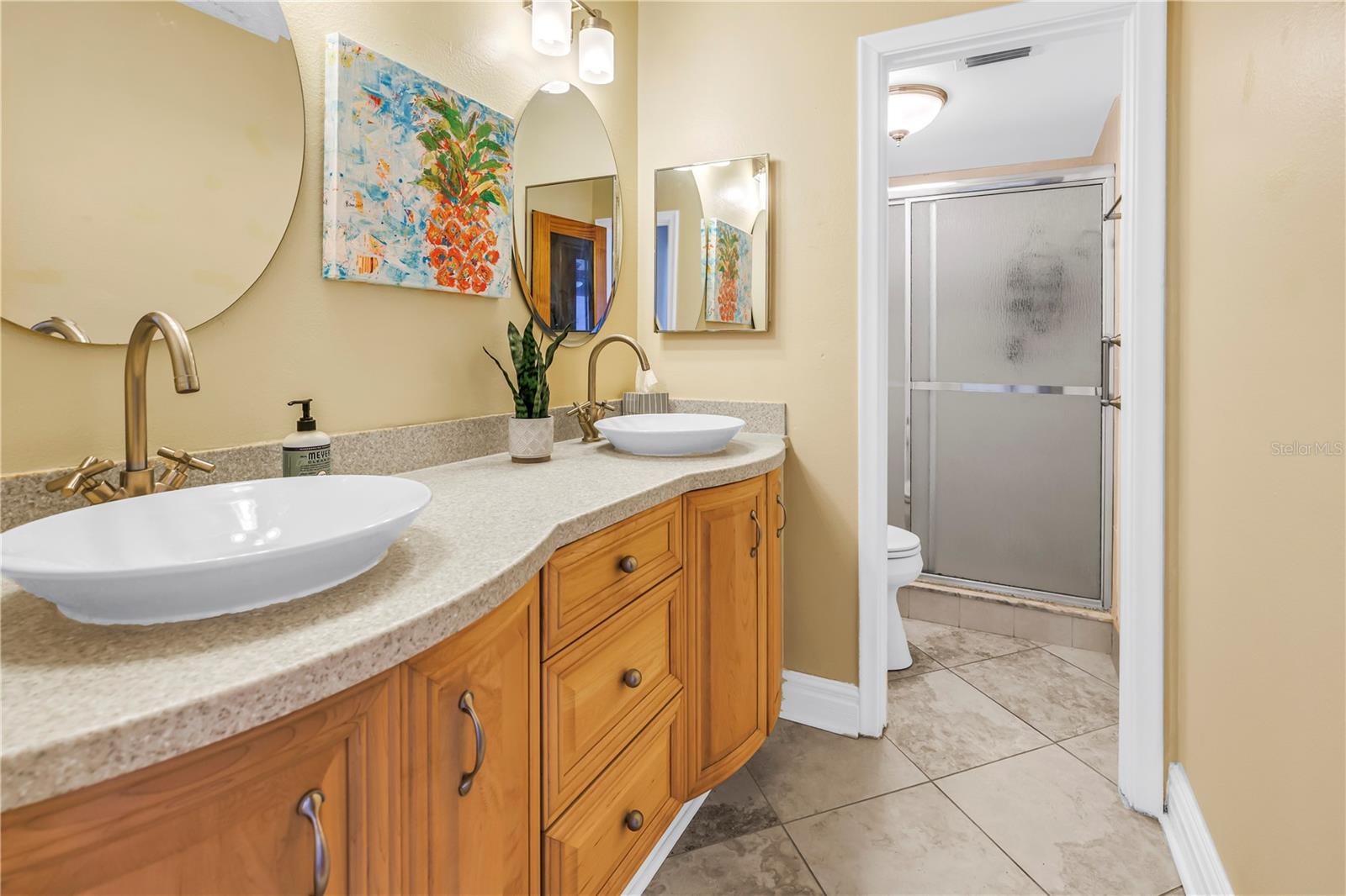 Guest bath has double sinks and shower