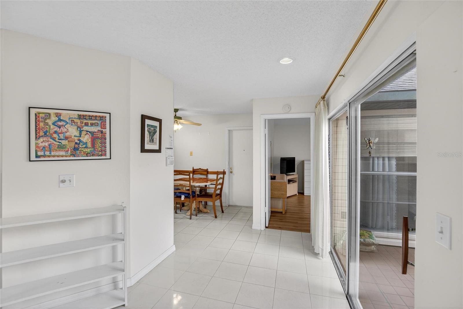 Sliding glass doors to go to the patio and entry to the Primary Bedroom