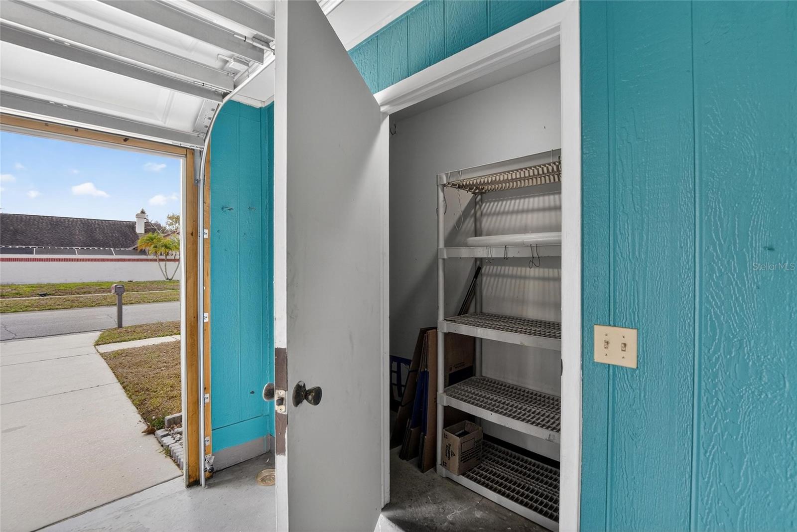 Extra storage closet in garage with hot water heater