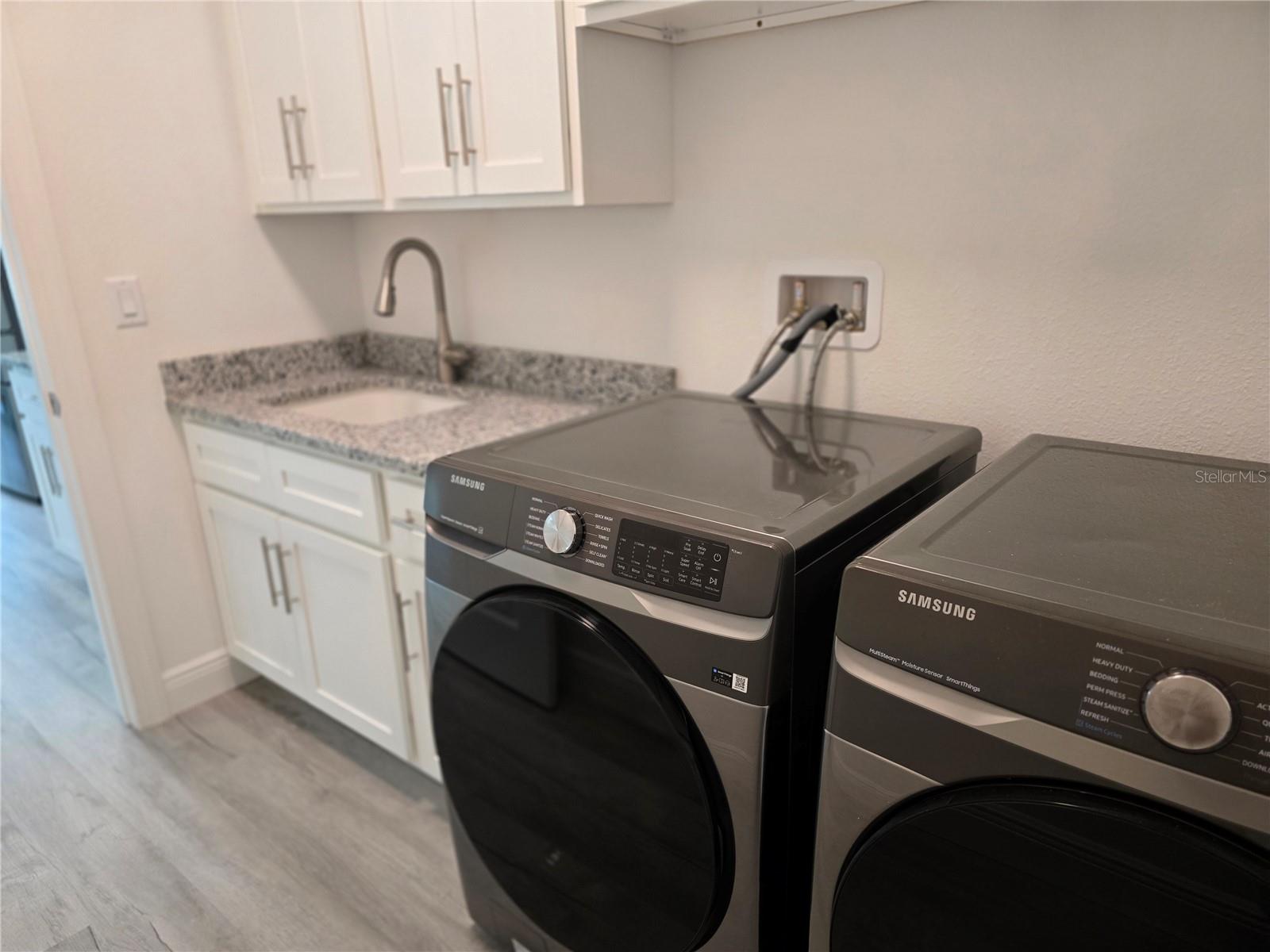 LAUNDRY ROOM SINK AND CABINETS