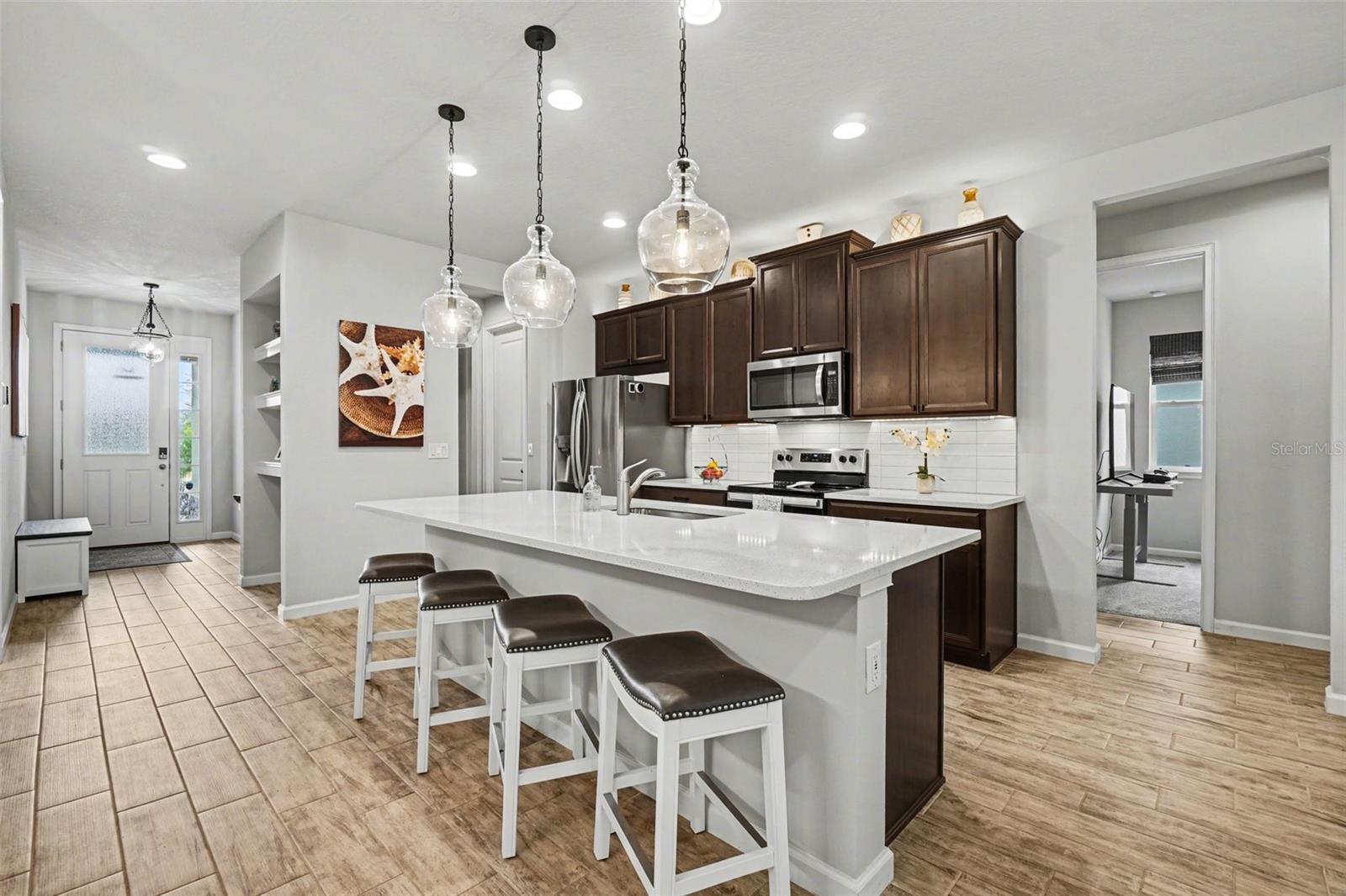 3 Gorgeous Pendant Lights and Over and Under-Cabinet Lighting Illuminate this Gorgeous Kitchen.