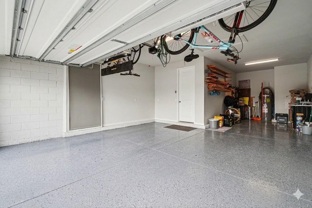 3-Stall Tandem-Style Garage w/ Epoxy Floor & Built-In Hanging Storage Racks.