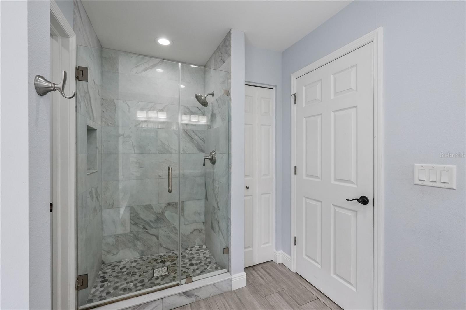 This tile shower has been updated in the Primary Bathroom