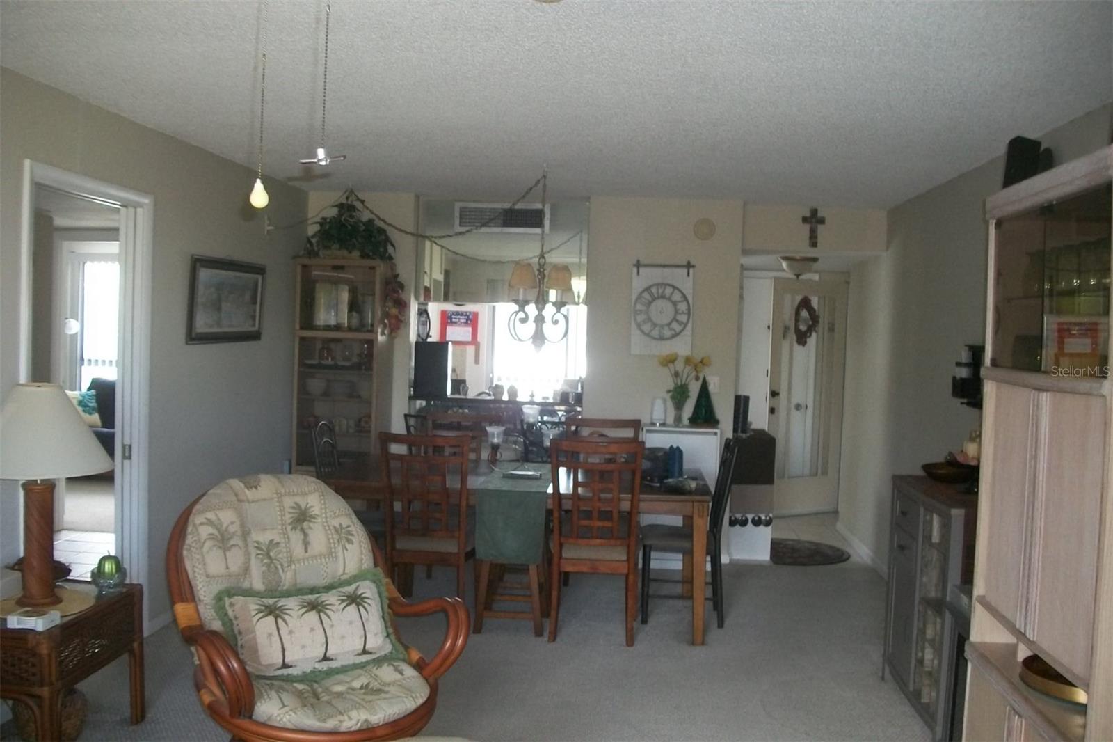 Standing Living room looking back into Dining area plus Kitchen has pass through