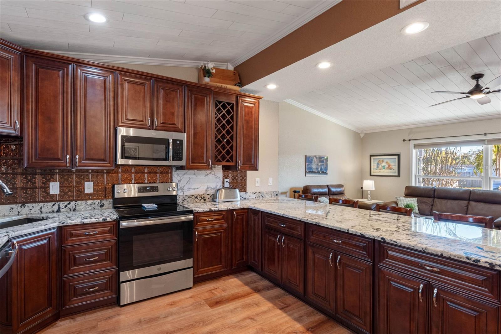 ... Kitchen shot #5.... Open Floorplan allows chef to prep while still controlling Living Room Area.  Perfect for entertaining or easy living. NOTE: Bottom Extra Cabinetry under Breakfast Bar.
