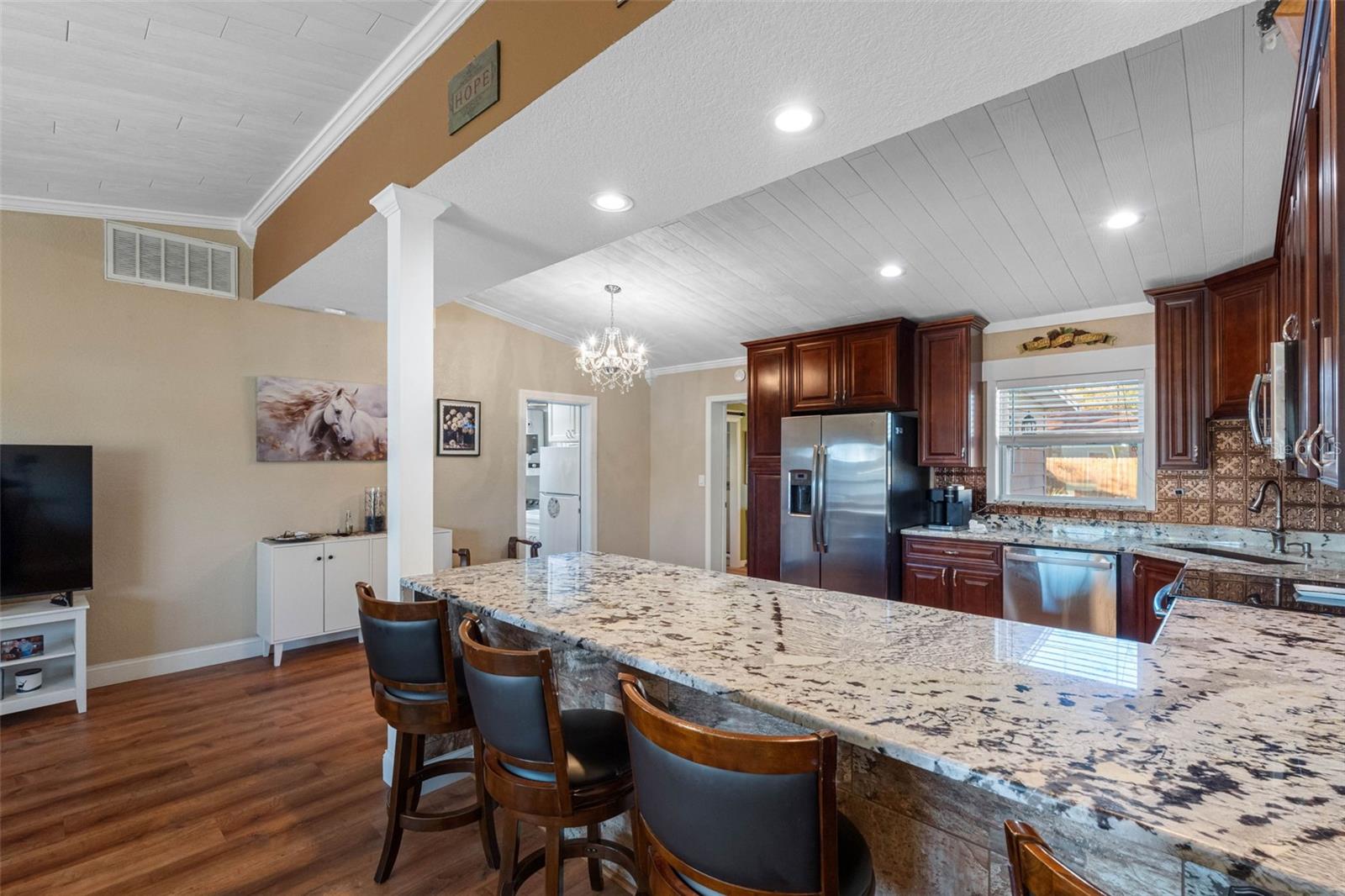 ... Kitchen Shot  #6... Showcasing Granite Breakfast Bar. Very Functional Layout.. Vaulted Ceiling  provide Interior Design with a very modern look.