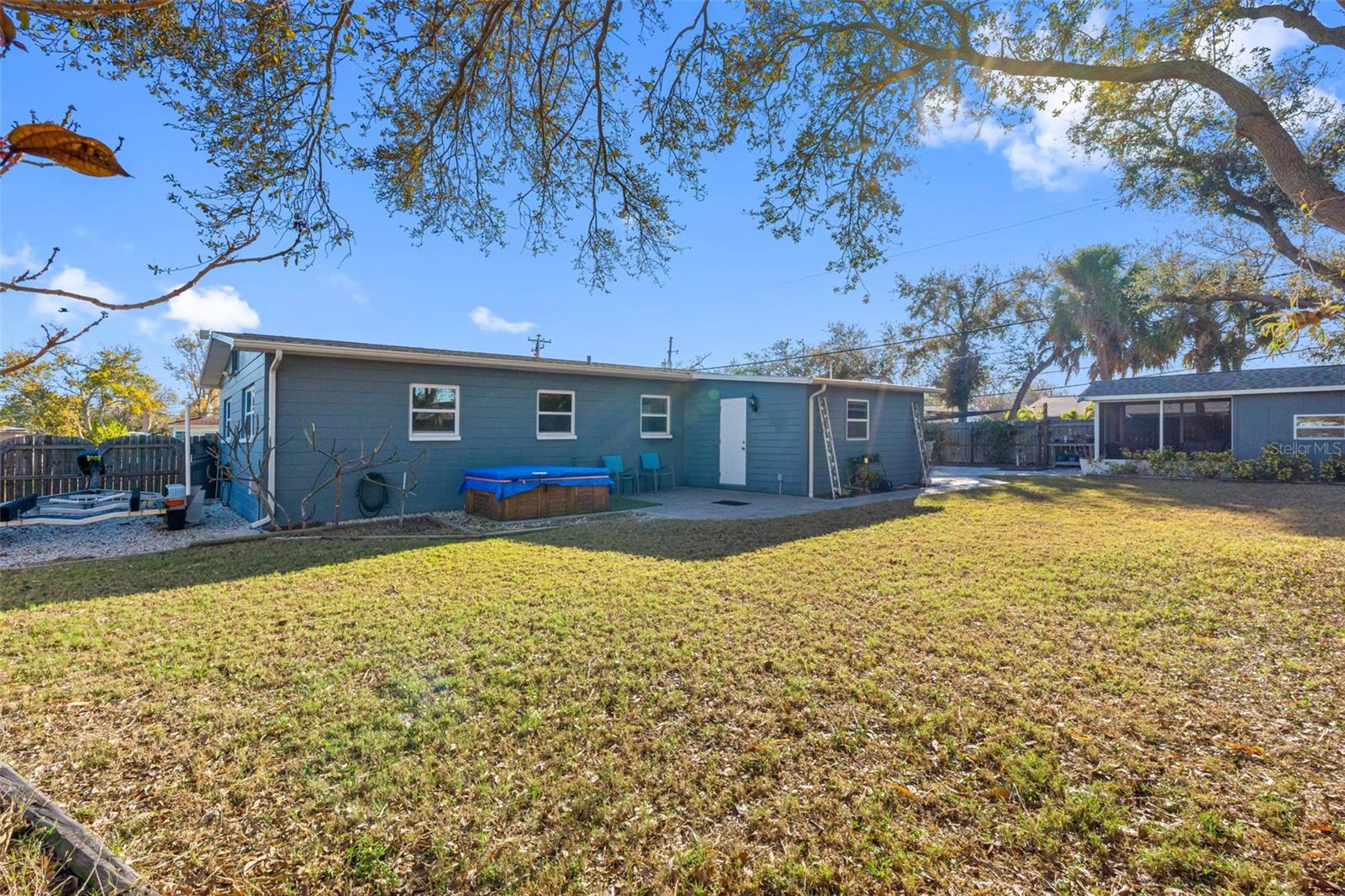 ...Another Shot of Yard.. She Shed on Right with Enclosed Lounging Area. Photo from East side of Yard. White Door is from Home Office to Backyard..