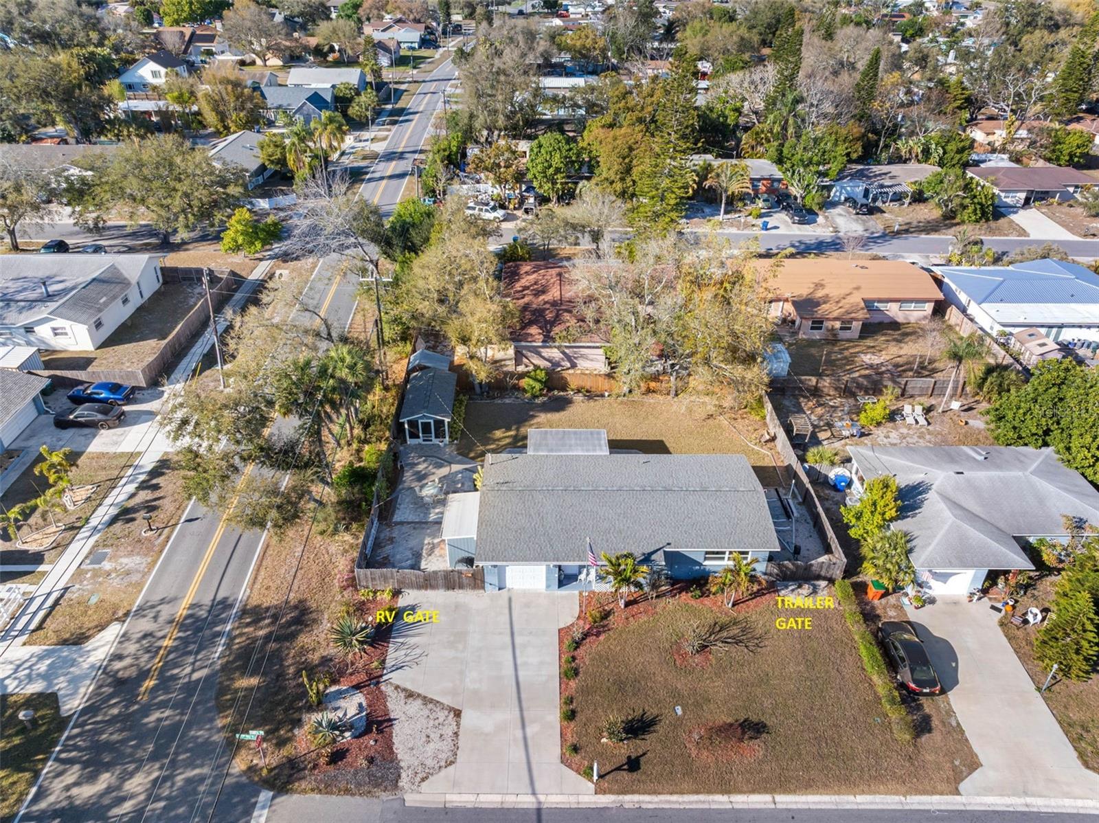 Corner Lot Affords RV Parking on the Left and Boat Trailer Parking on the Right... Perfect also for Work Truck behind either Gate.
