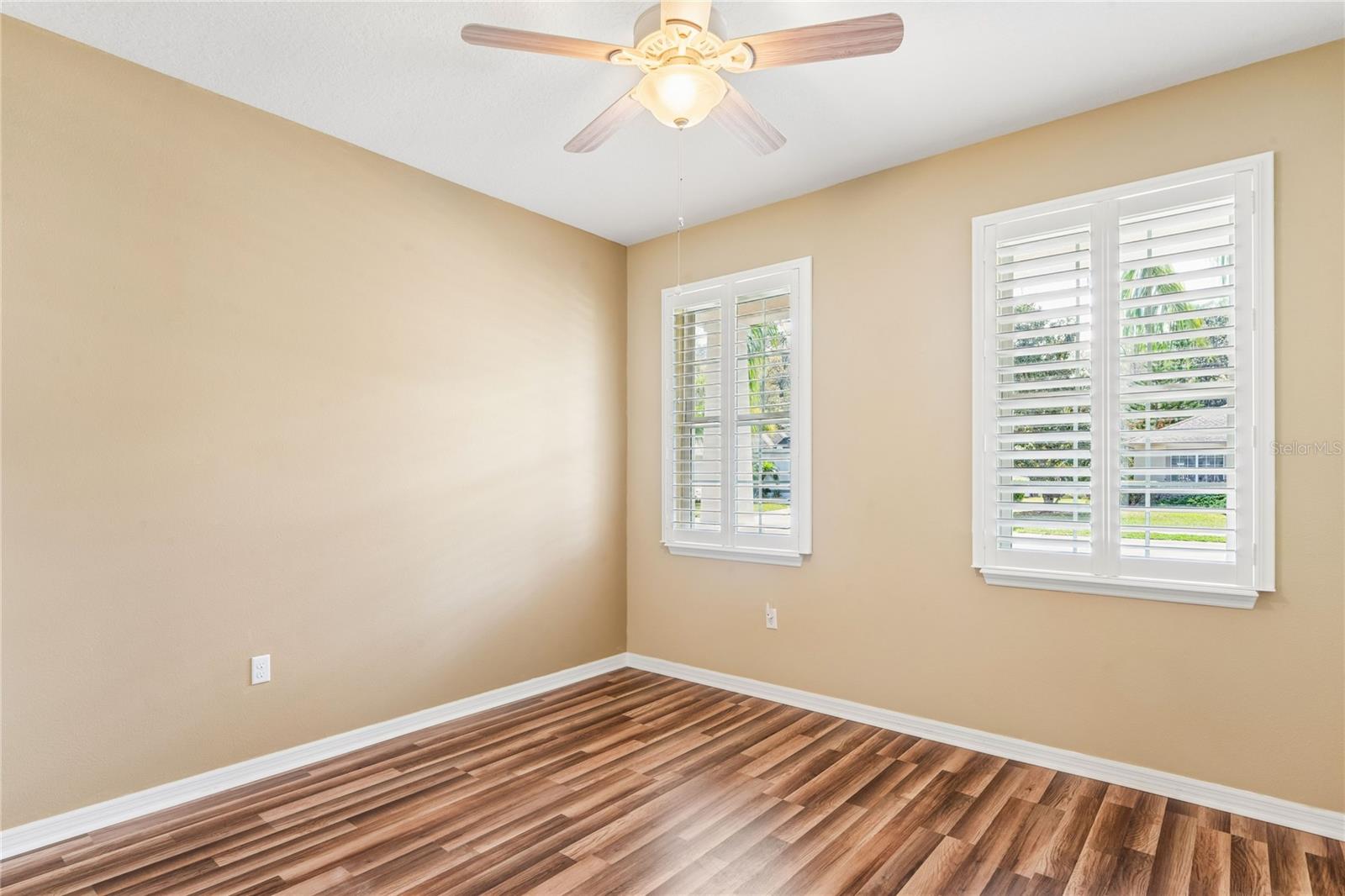 BEDROOM 2 WITH CEILING FAN AND WINDOW SHUTTERS