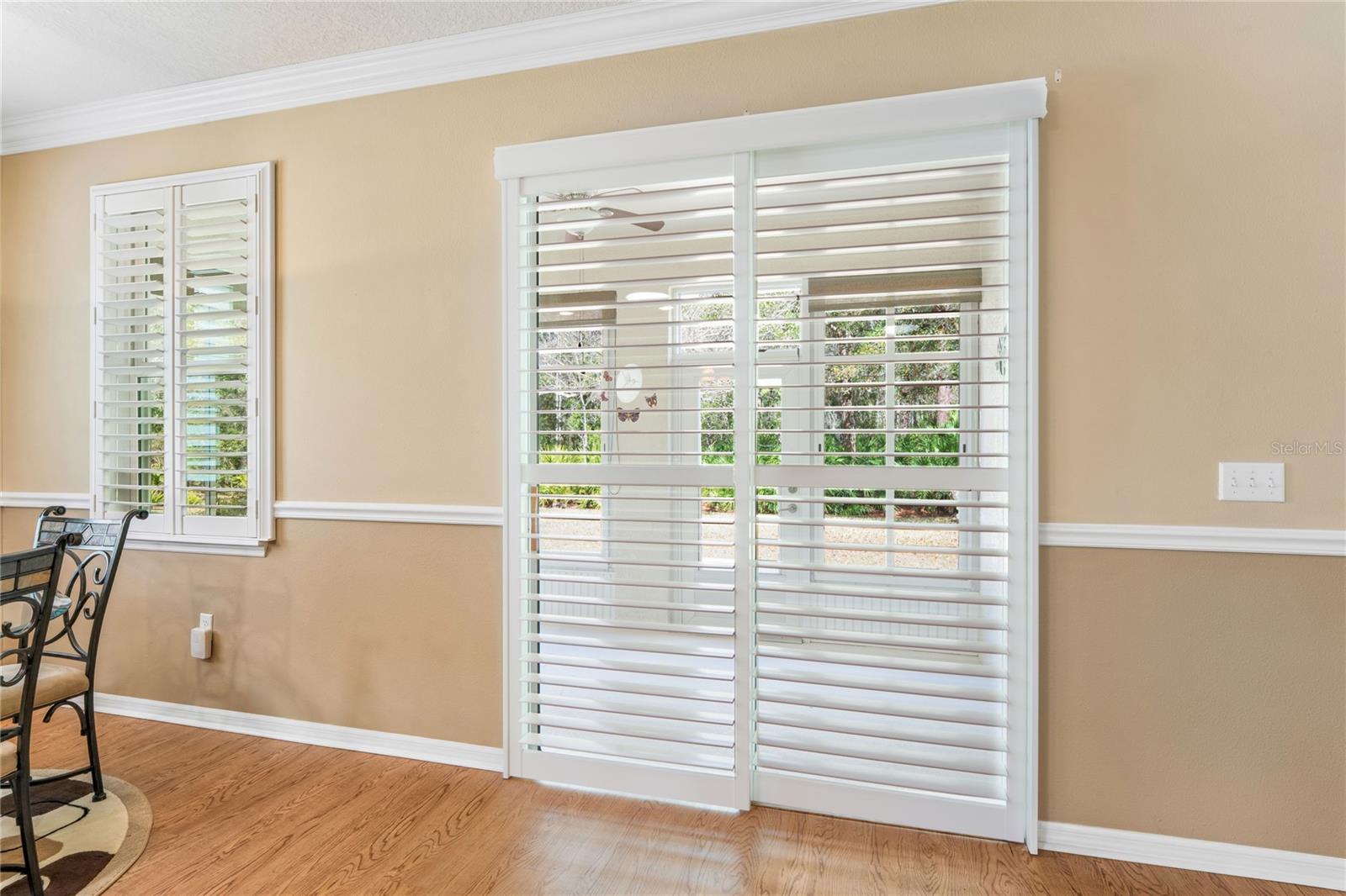 EXIT TO YOUR ENCLOSED LANAI/CUSTOM SHUTTERS THROUGHOUT HOME