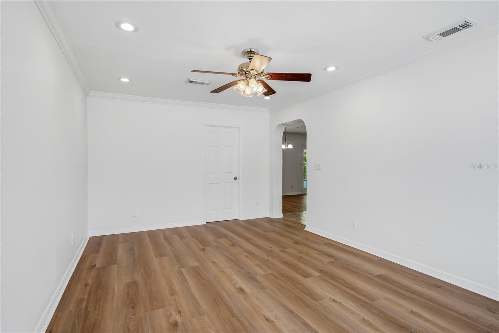 Bonus room looking toward the kitchen entry and laundry room door