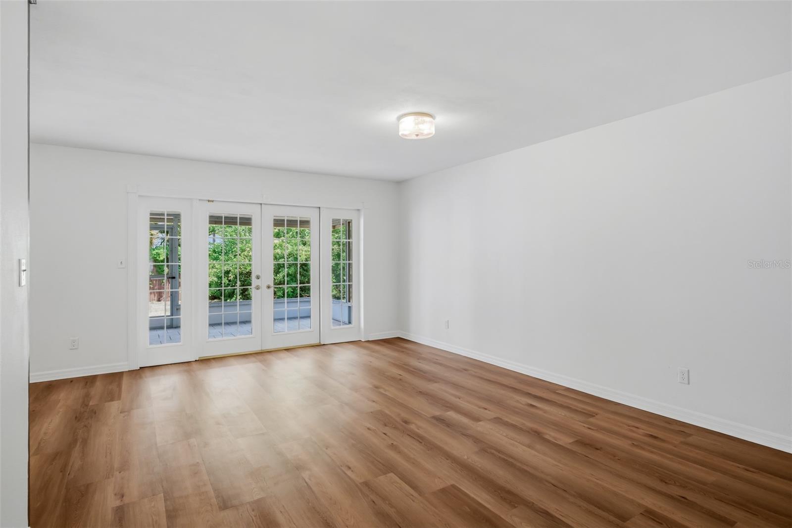 view of Living room from front door area with French Doors to back screened porch