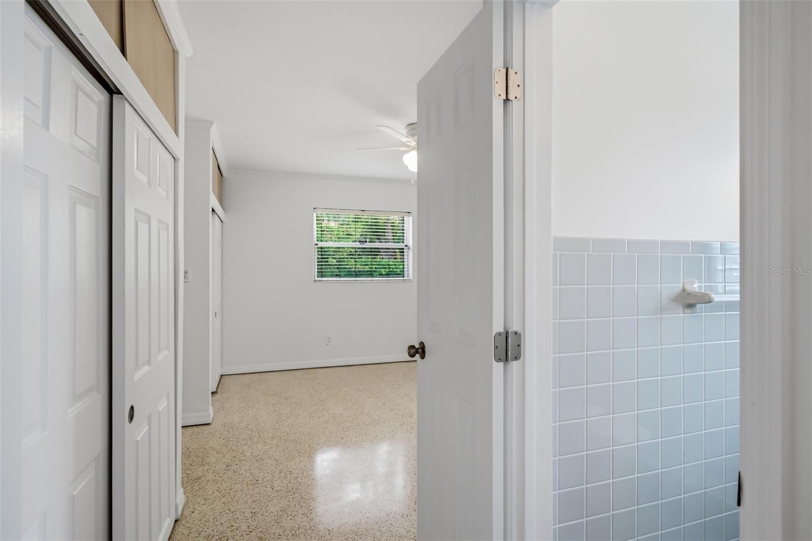 View of primary bedroom and ensuite bathroom