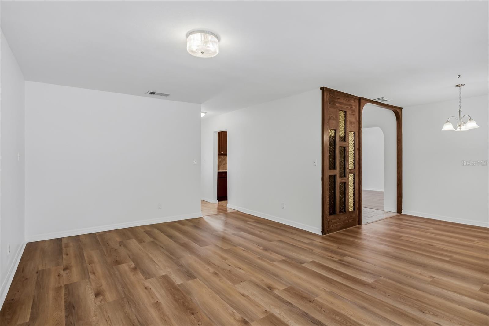 Living room with view of the dinning area and entry into the Kitchen
