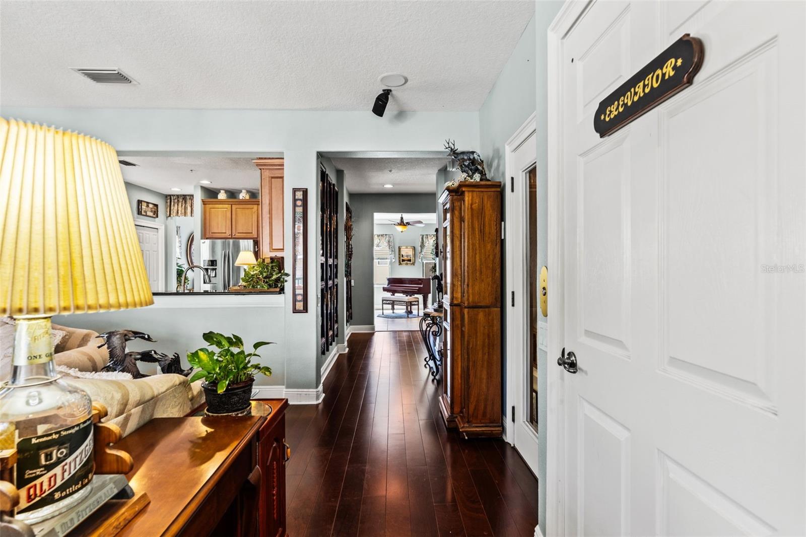 Wide interior hallway with wood flooring and views toward the living areas, creating a smooth flow throughout the home.