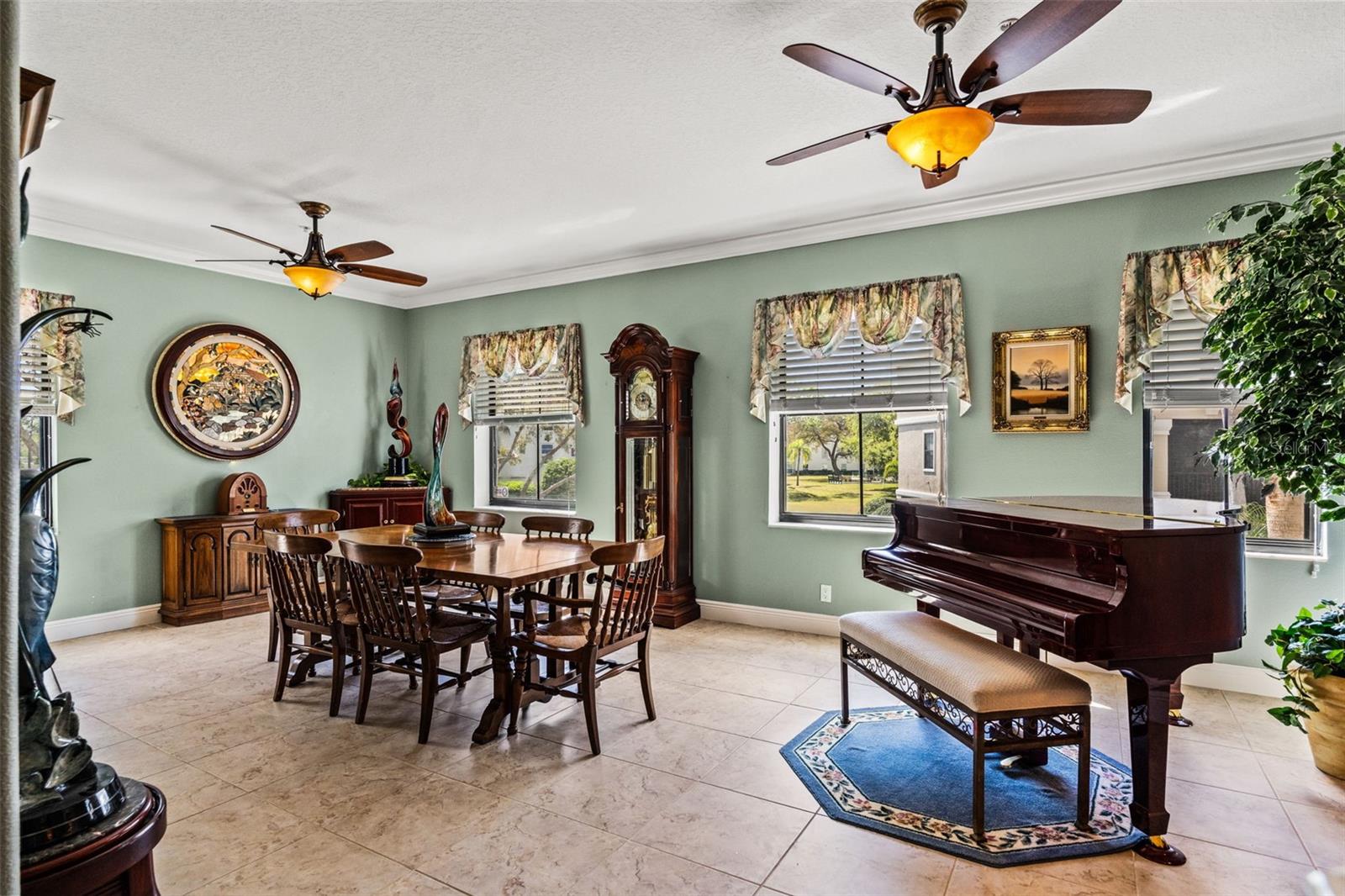 Elegant dining room with tile flooring, large windows, and generous space for hosting gatherings.