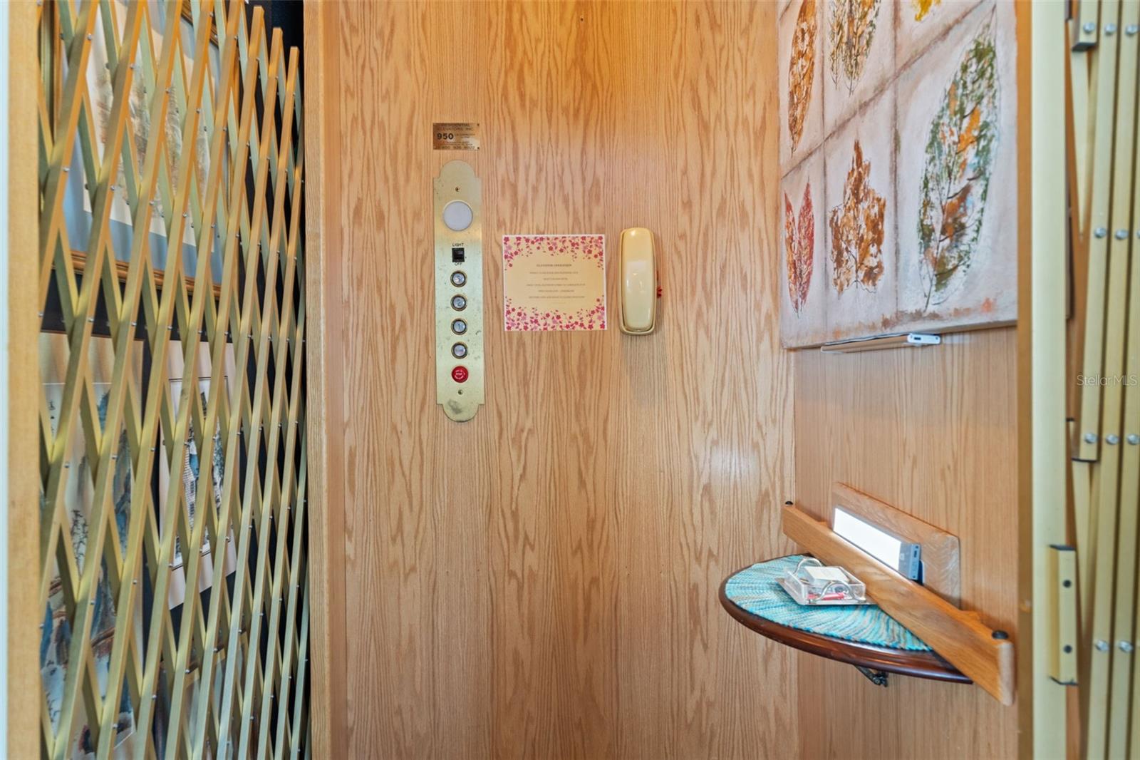 Convenient private elevator with wood-paneled interior, providing easy access between levels of the residence.