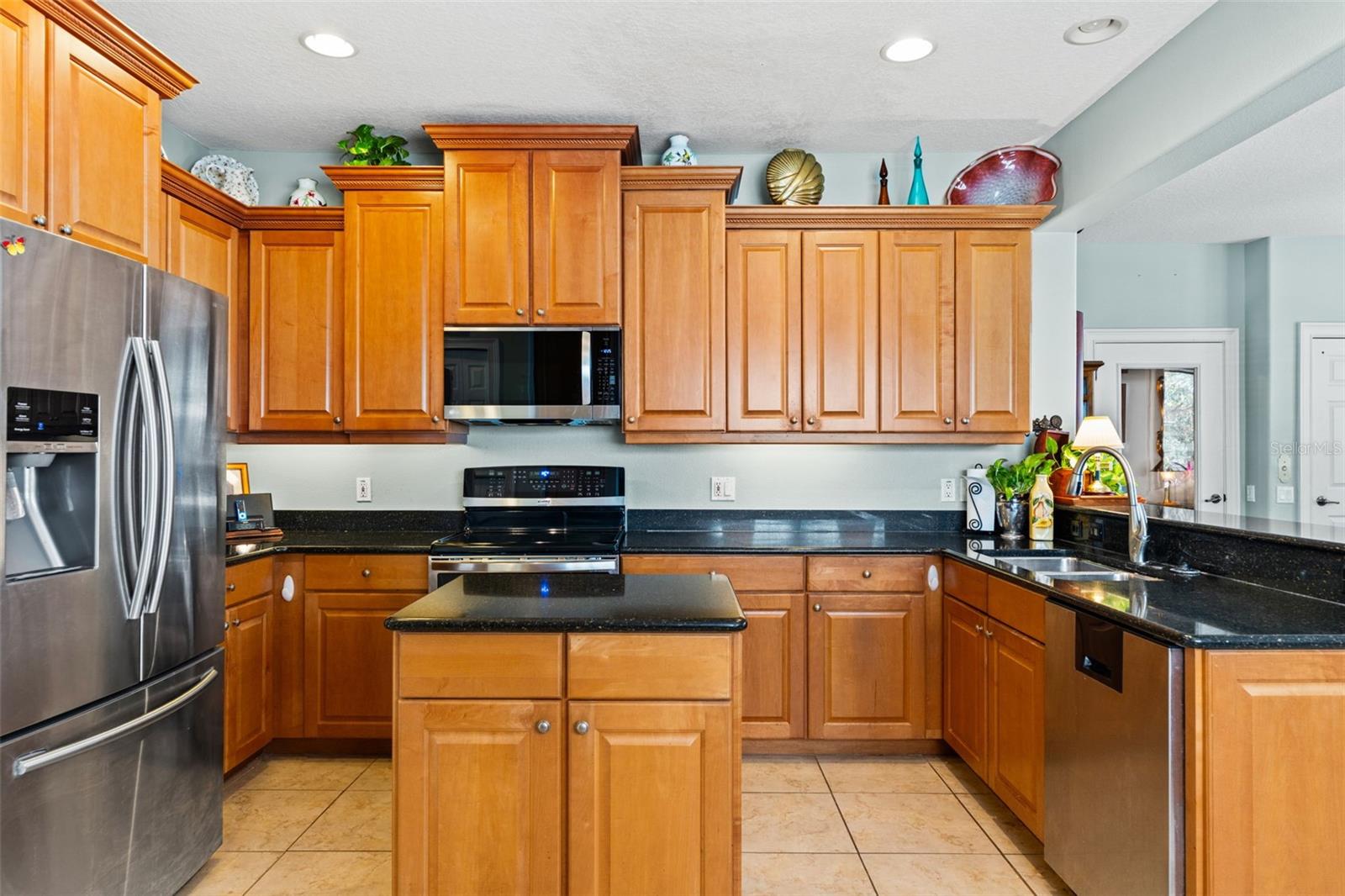 Well-appointed kitchen with extensive cabinetry, sleek appliances, and generous counter space for cooking and hosting.