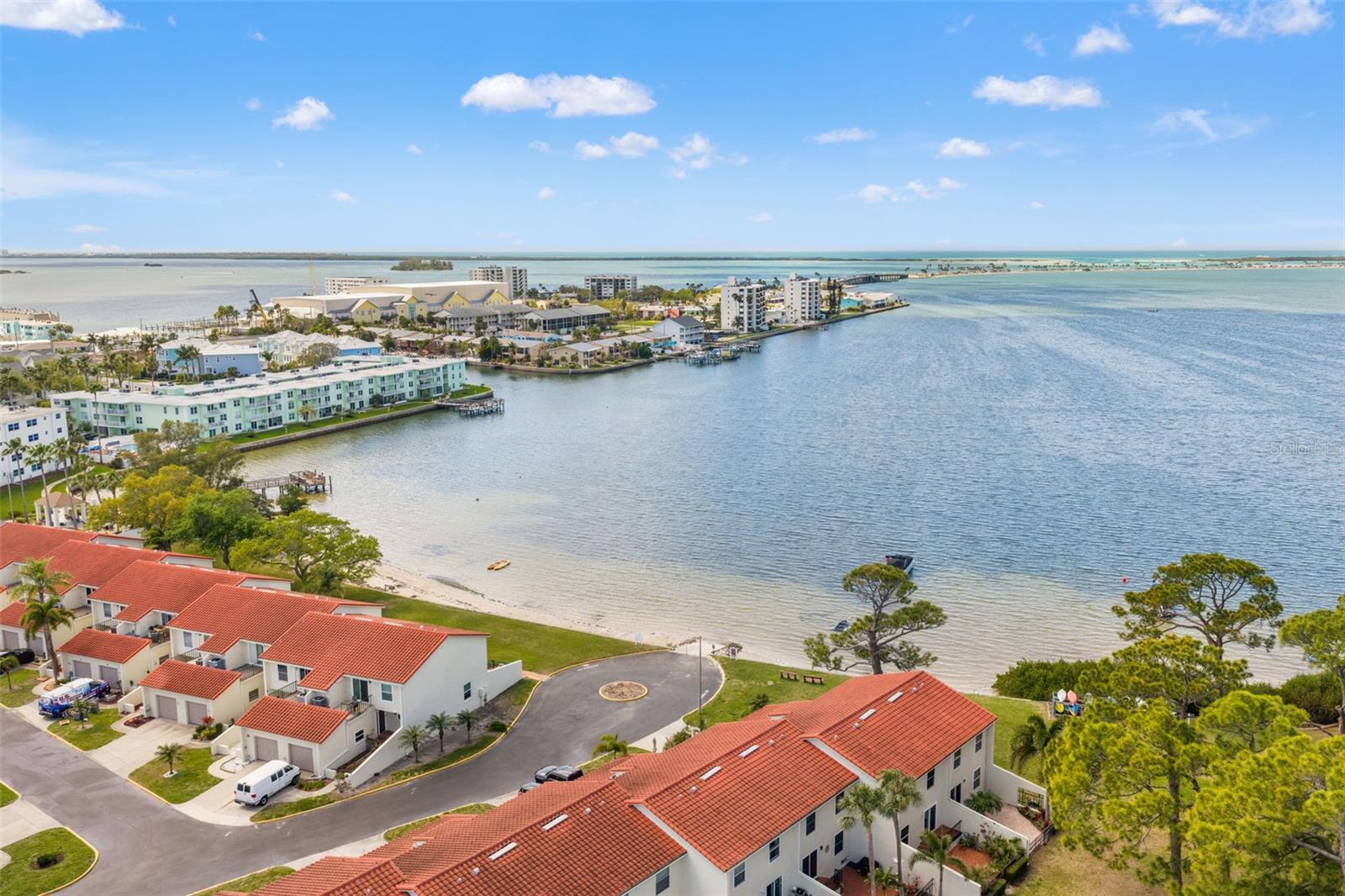 Expansive aerial view of the bay and surrounding shoreline, highlighting the community’s close proximity to the water.