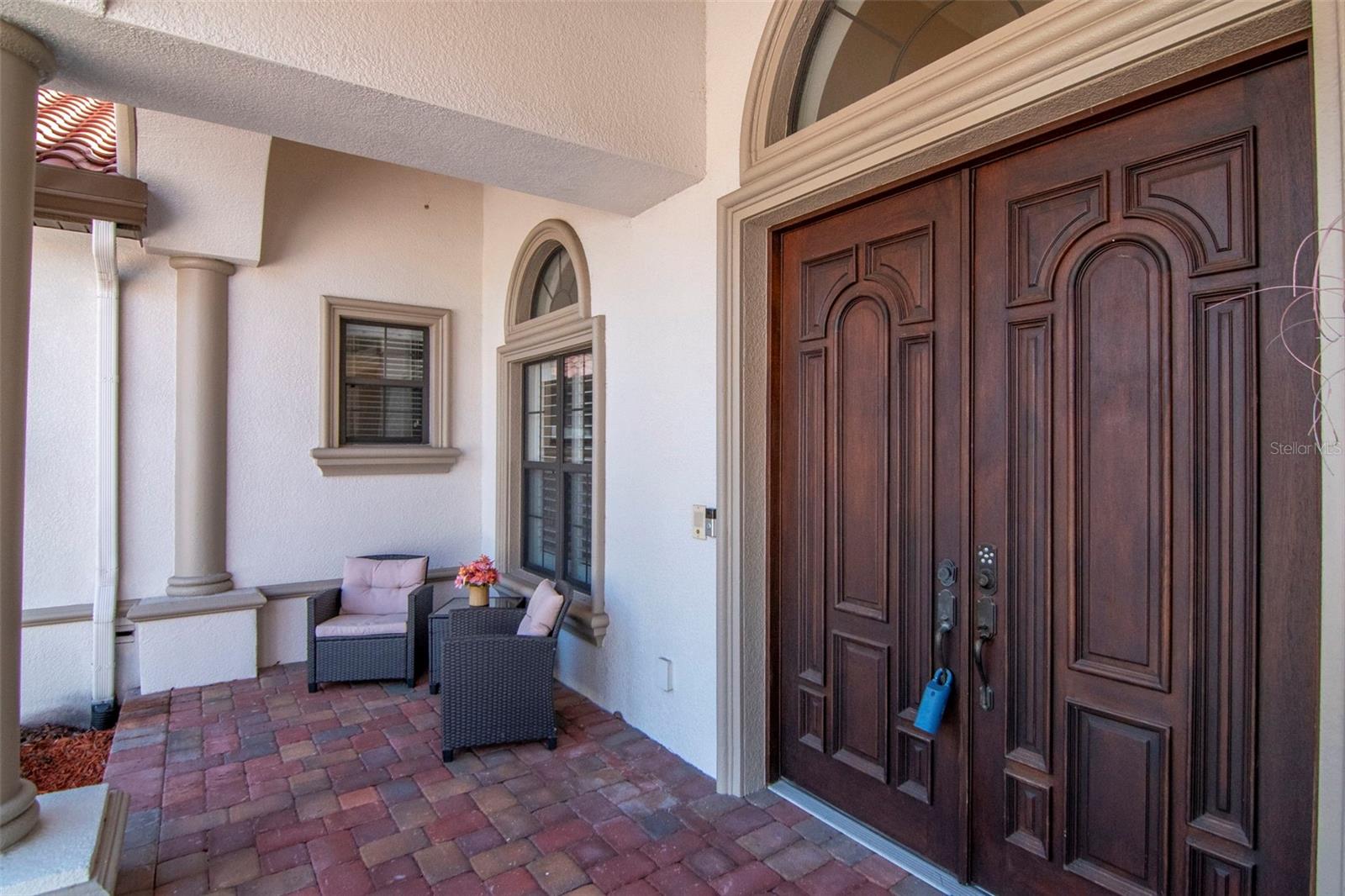 double door entrance with sitting are area on front porch