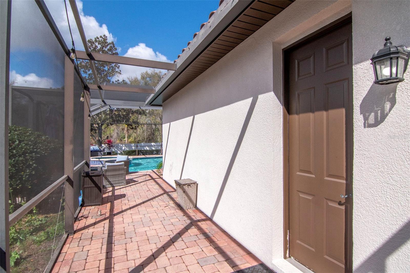 side patio with door to pool bathroom off living room