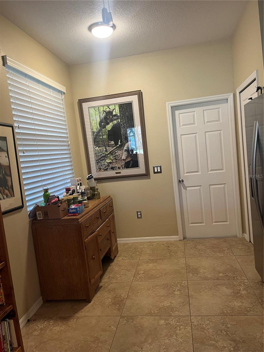 BREAKFAST NOOK AREA IN KITCHEN.  DOOR LEADS TO GARAGE.