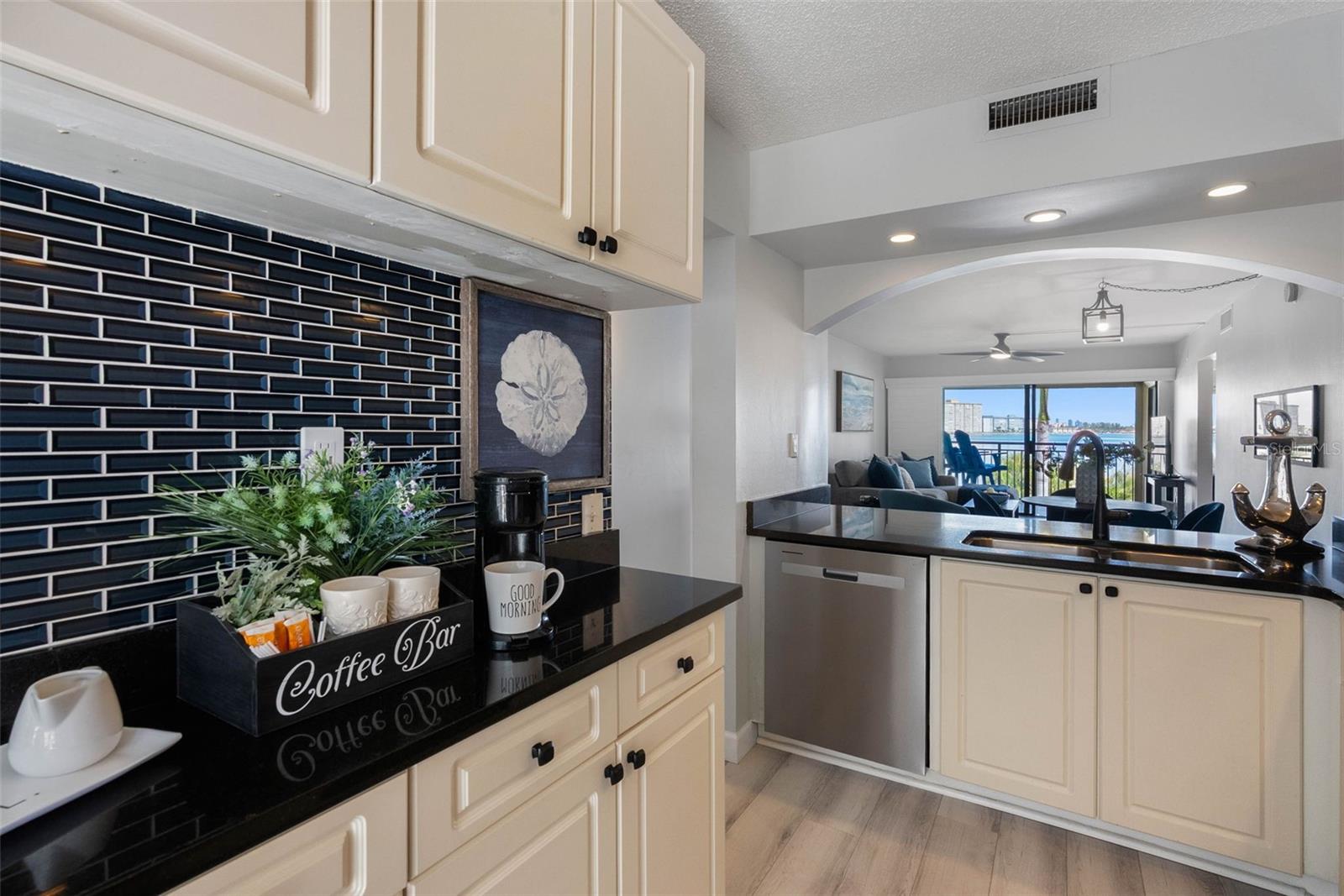 Coastal Glass Tile Backsplash and Stainless Appliances