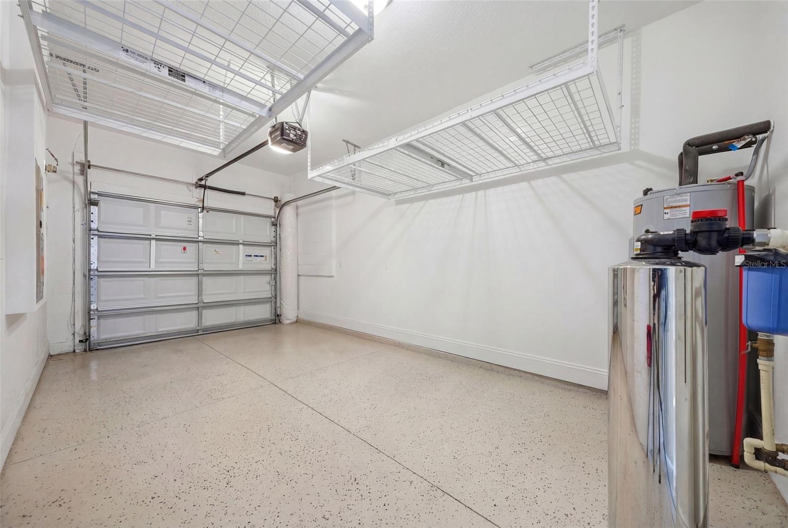one car garage with extra shelving and water filtration and softner system, plus a tesla charge station