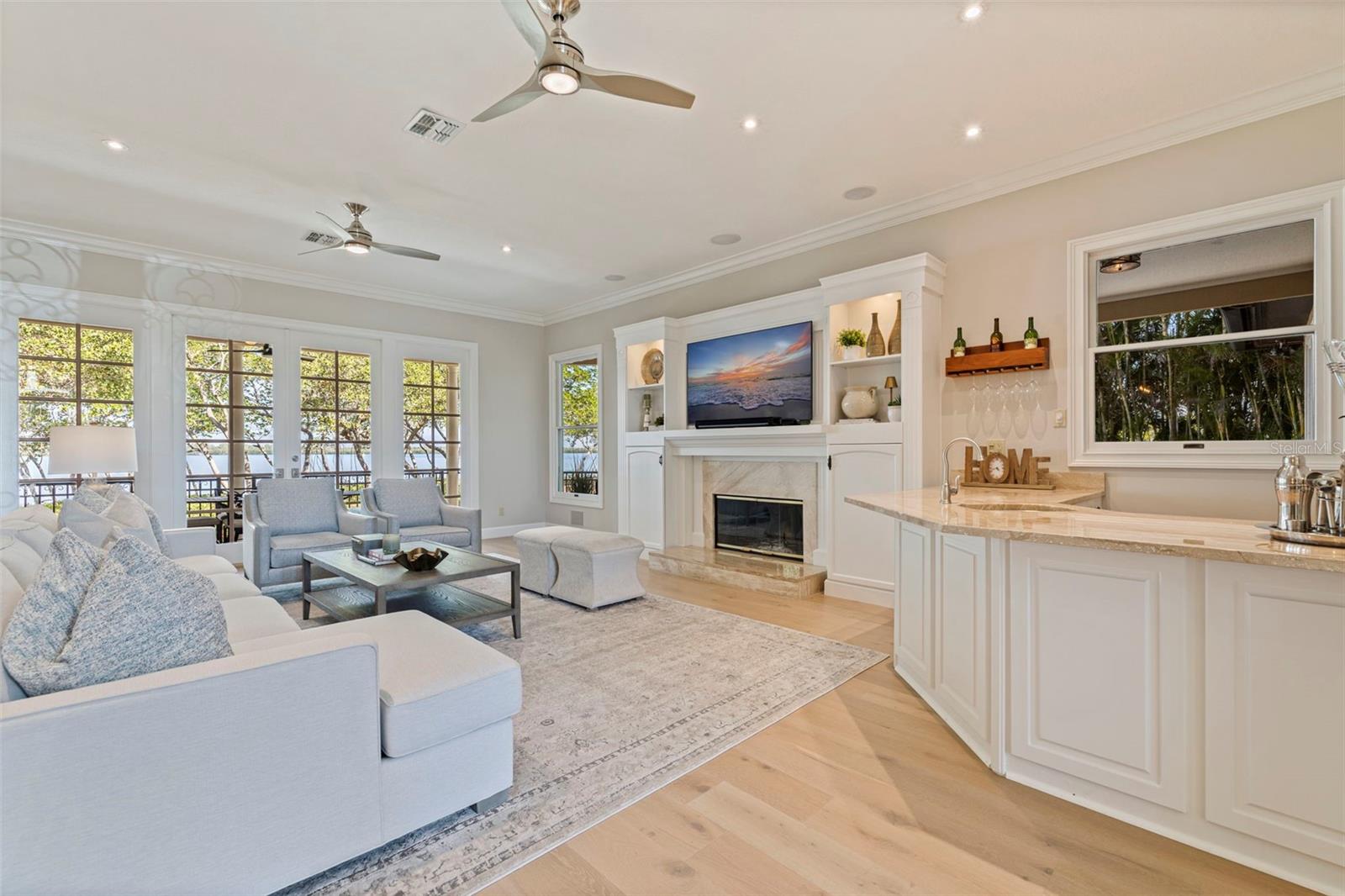 Living room with wood burning fireplace & wetbar