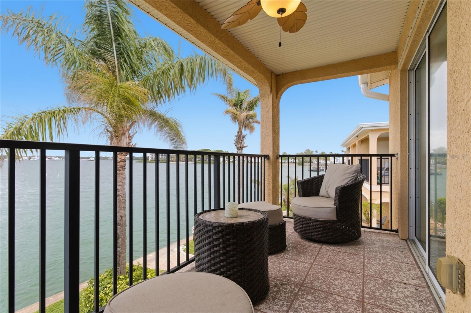 Spacious Balcony/Patio with back door and staircase to Backyard and water