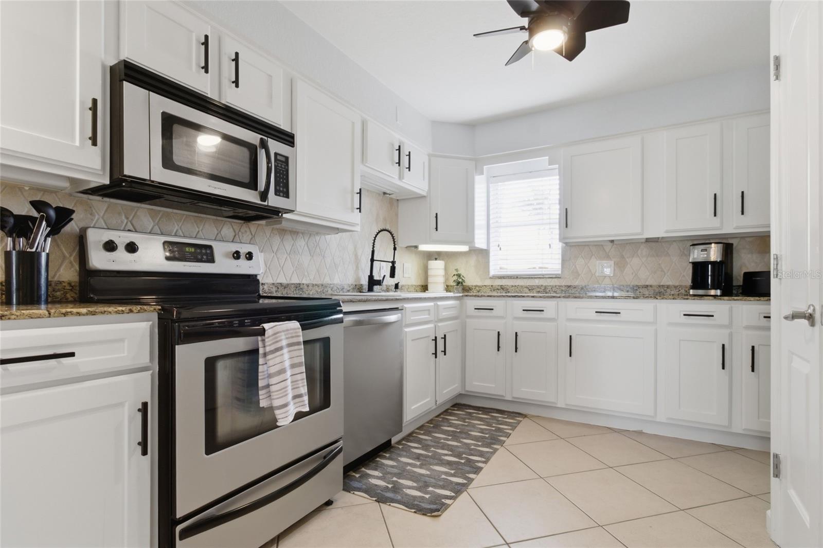 Updated Kitchen with granit counteres and solid wood cabinetry, crown molding