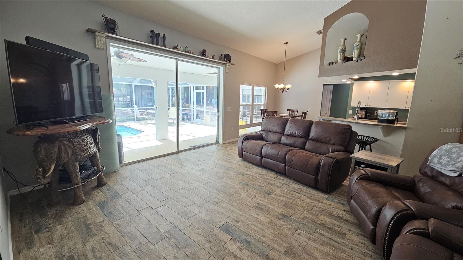 view of the pool and backyard from the living room