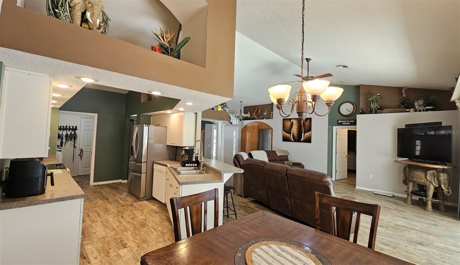Spacious Open Floor plan showing kitchen & living room with vaulted ceilings