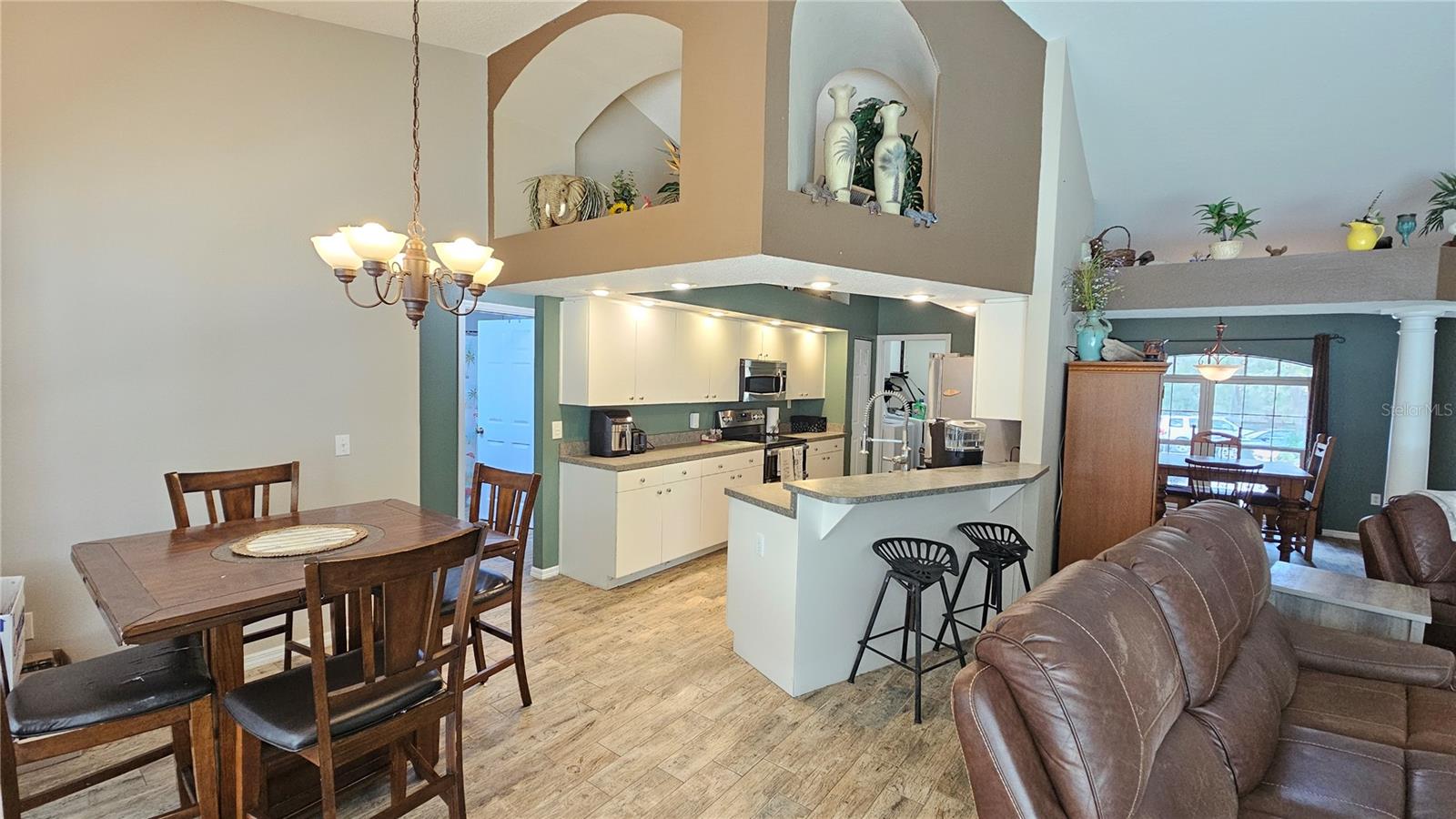 Spacious Open Floor plan showing kitchen & living room with vaulted ceilings