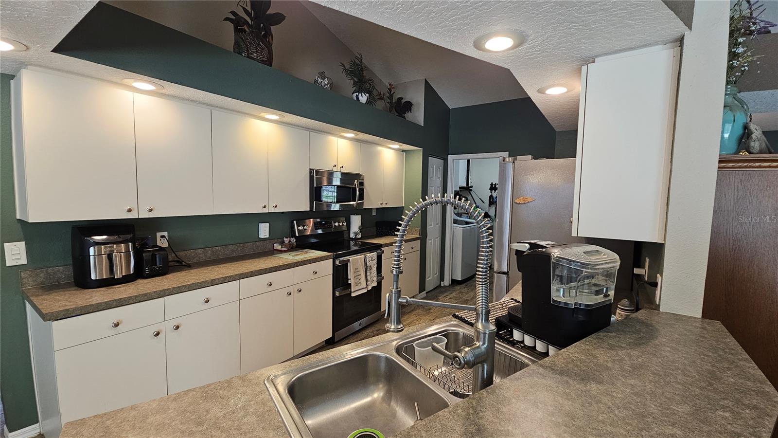 Open kitchen with high top breakfast bar