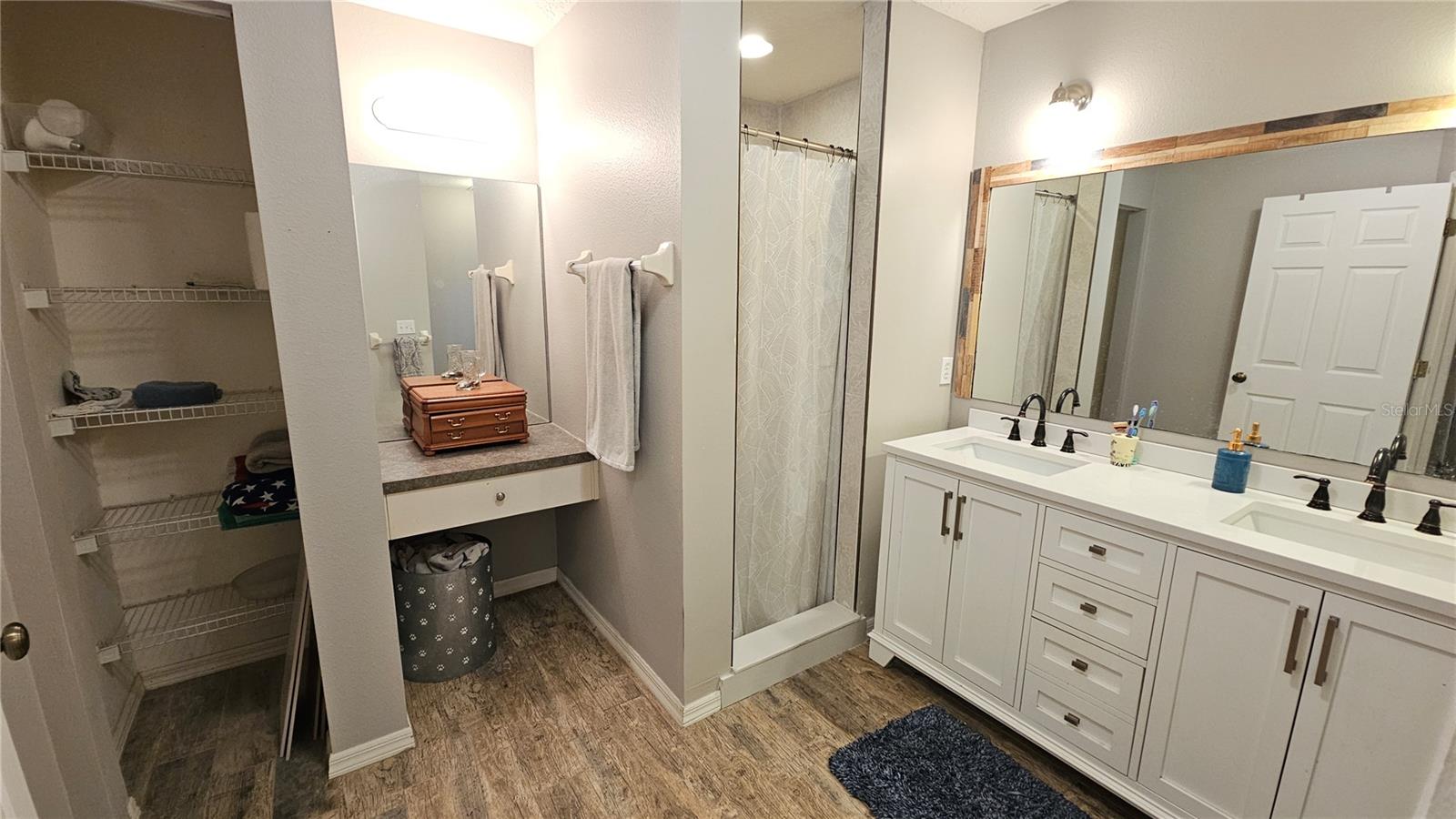 Master Bathroom with newly updated shower & dual sink vanities, makeup vanity & linen closet