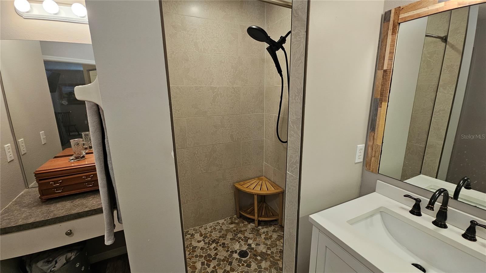 Master Bathroom with newly updated shower & dual sink vanities, makeup vanity & linen closet