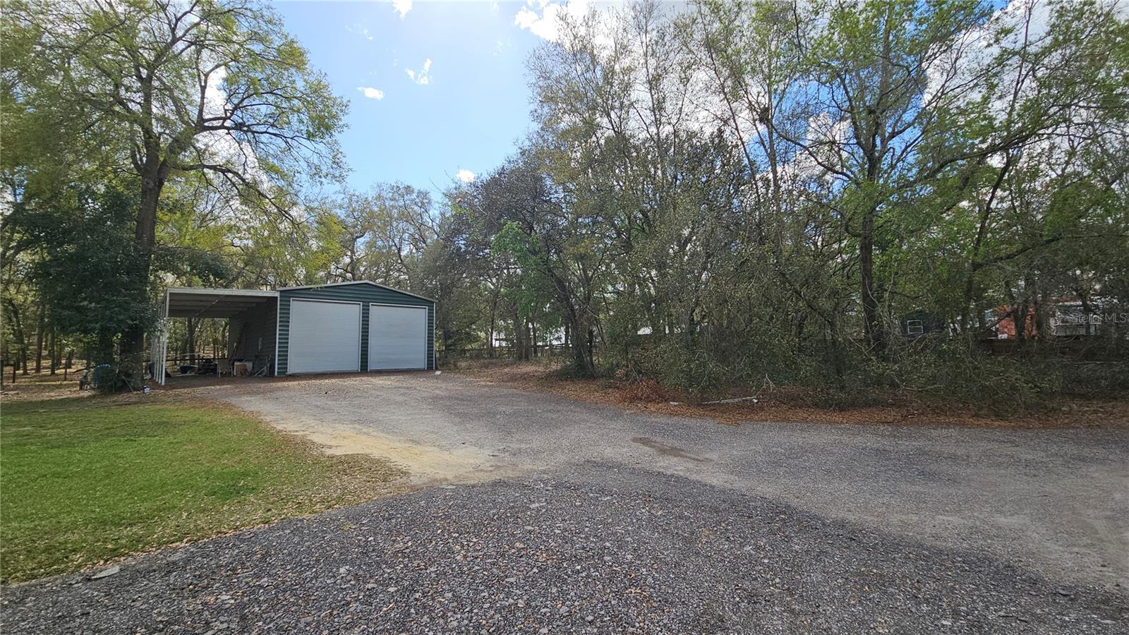 View of huge metal building/shop and long driveway