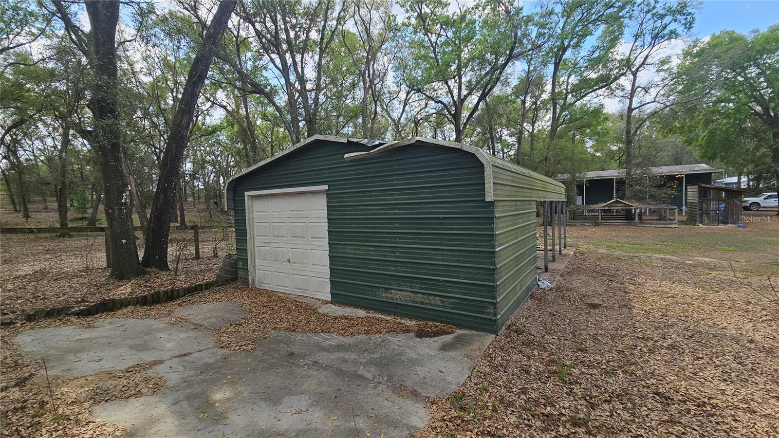 Covered area for entertaining or to shelter animals, complete w/ attached garage