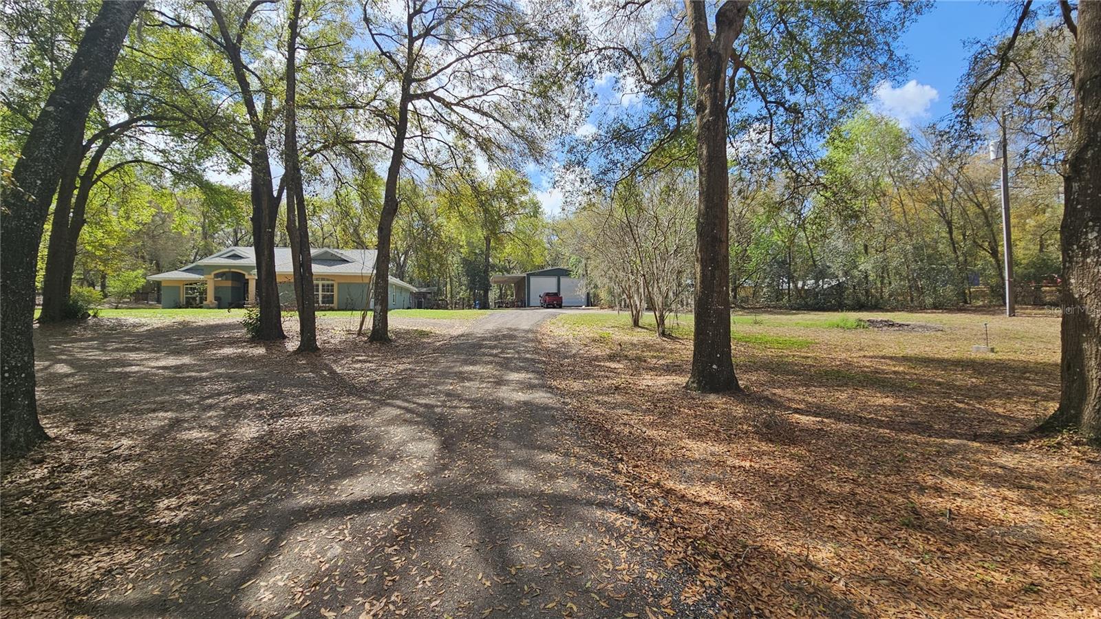 View of front of home from the front road entrance at gate