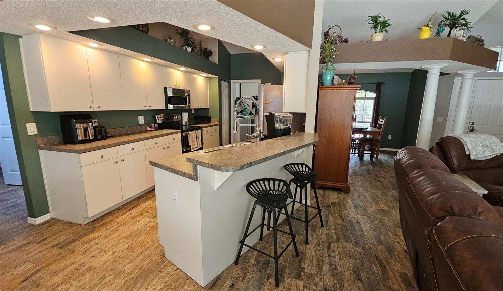 Open kitchen with high top breakfast bar