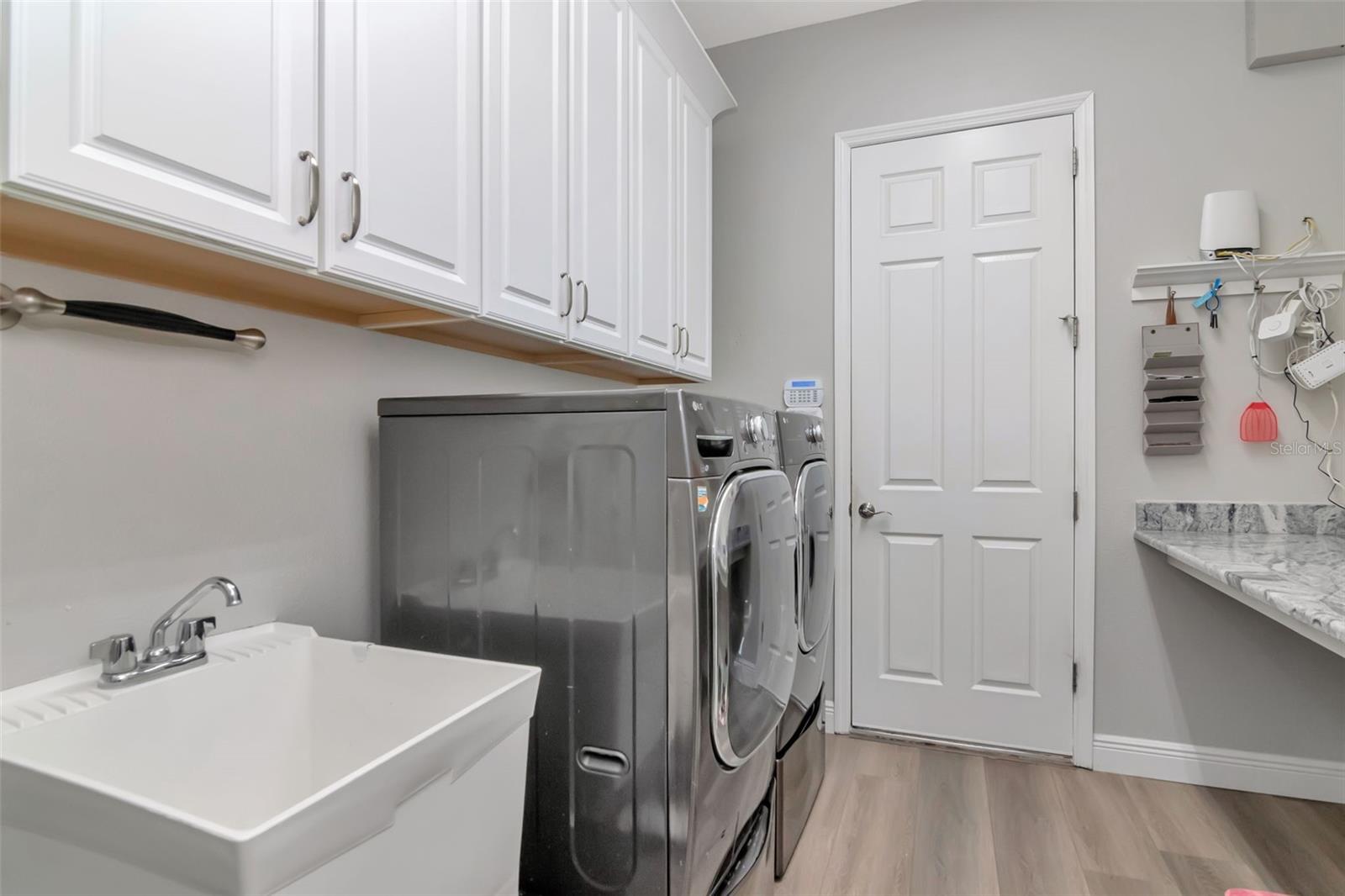 Functional Laundry Room w/Folding Counter, Cabinets & Utility Sink