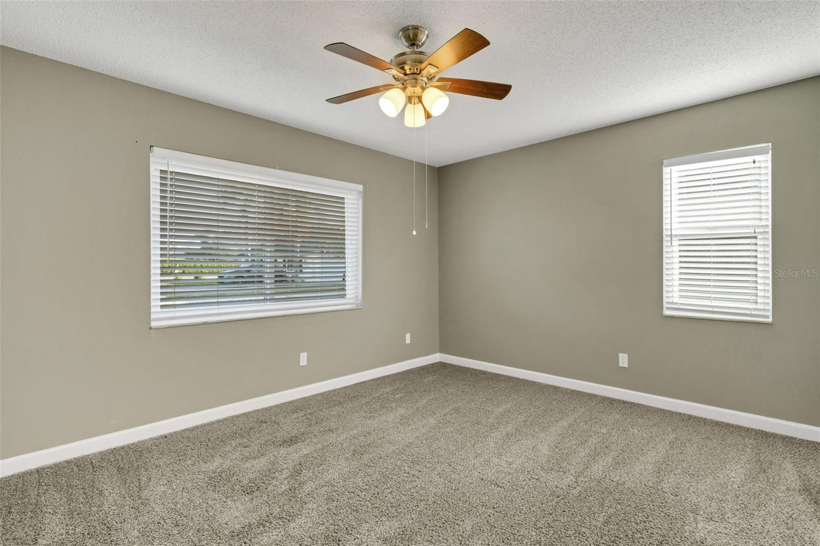 Guest bedroom with dual windows.