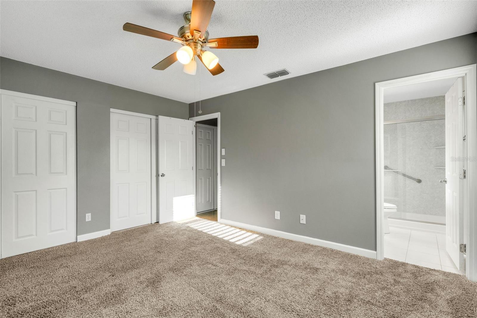 Primary bedroom with dual closets and ensuite